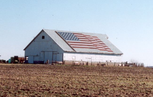 Art-Loc shingle roof with an American flag design installed on a barn roof